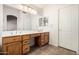 Bathroom featuring double vanity with wooden cabinets and a large mirror at 4102 E Cathedral Rock Dr, Phoenix, AZ 85044