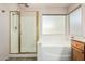 Bathroom with glass shower enclosure and a soaking tub at 4102 E Cathedral Rock Dr, Phoenix, AZ 85044