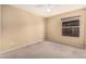 Guest bedroom with a ceiling fan, plush carpet floors, and a large window at 4102 E Cathedral Rock Dr, Phoenix, AZ 85044