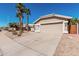 Spacious driveway leading to a two-car garage, complemented by desert landscaping at 4102 E Cathedral Rock Dr, Phoenix, AZ 85044