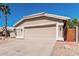 Attached two-car garage featuring ample parking space, complemented by desert landscaping at 4102 E Cathedral Rock Dr, Phoenix, AZ 85044