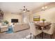 Open-concept living room featuring neutral furniture, a ceiling fan, and a dining area with seating for six at 4102 E Cathedral Rock Dr, Phoenix, AZ 85044