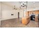 Open-concept living room with kitchen island, ceiling fan, and neutral tones at 4102 E Cathedral Rock Dr, Phoenix, AZ 85044