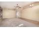 Spacious living room with neutral walls, a ceiling fan, and tile and carpet flooring at 4102 E Cathedral Rock Dr, Phoenix, AZ 85044