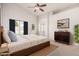 Bright main bedroom with large window, ceiling fan, ensuite bath, and a modern dresser at 4102 E Cathedral Rock Dr, Phoenix, AZ 85044
