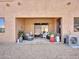 Charming covered back patio with comfortable wicker furniture and decorative potted plants at 4241 N Pebble Creek Pkwy # 42, Goodyear, AZ 85395