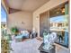 Inviting outdoor back patio with cozy wicker seating, plants, and stylish decor at 4241 N Pebble Creek Pkwy # 42, Goodyear, AZ 85395