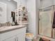 Well-appointed bathroom featuring a granite countertop, decorative shelves, and a glass-enclosed shower at 4241 N Pebble Creek Pkwy # 42, Goodyear, AZ 85395