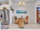 Charming dining area features wicker chairs, a glass table, and a view of the kitchen at 4241 N Pebble Creek Pkwy # 42, Goodyear, AZ 85395