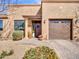 Stunning front exterior with meticulous landscaping, a decorative wreath on the front door, and a convenient attached garage at 4241 N Pebble Creek Pkwy # 42, Goodyear, AZ 85395