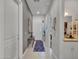 Inviting hallway featuring neutral tones, tiled flooring, an elegant runner, and a charming console table near the front door at 4241 N Pebble Creek Pkwy # 42, Goodyear, AZ 85395