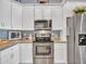 Close-up of a well-equipped kitchen with stainless steel appliances, white cabinetry and backsplash, with granite countertops at 4241 N Pebble Creek Pkwy # 42, Goodyear, AZ 85395