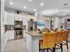 Modern kitchen featuring white cabinets, stainless steel appliances, an island with bar stools and granite countertops at 4241 N Pebble Creek Pkwy # 42, Goodyear, AZ 85395