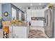 Spacious kitchen featuring granite countertops, stainless steel appliances, ample white cabinetry, and a view of the breakfast bar at 4241 N Pebble Creek Pkwy # 42, Goodyear, AZ 85395