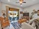 Cozy living room with wicker furniture, ceiling fan, and sliding glass doors to the patio at 4241 N Pebble Creek Pkwy # 42, Goodyear, AZ 85395