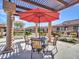 Charming outdoor dining area shaded by a pergola, perfect for enjoying meals al fresco at 4241 N Pebble Creek Pkwy # 42, Goodyear, AZ 85395