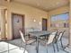 Covered patio area with a dining table and chairs, perfect for gatherings at 4241 N Pebble Creek Pkwy # 42, Goodyear, AZ 85395