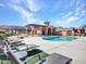 Community pool surrounded by lounge chairs, offering a relaxing outdoor space at 4241 N Pebble Creek Pkwy # 42, Goodyear, AZ 85395
