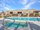 Community pool with a hot tub offers residents a refreshing retreat and a place to relax outdoors at 4241 N Pebble Creek Pkwy # 42, Goodyear, AZ 85395
