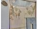 A decorative glass shower enclosure, adorned with floral patterns, adds a touch of elegance to the bathroom at 4241 N Pebble Creek Pkwy # 42, Goodyear, AZ 85395