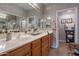 Bathroom featuring a double vanity, a large mirror, and lots of storage at 5450 E Mclellan Rd # G227, Mesa, AZ 85205