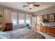 Comfortable bedroom featuring a ceiling fan, soft natural light, and matching wood furnishings at 5450 E Mclellan Rd # G227, Mesa, AZ 85205