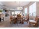 Open-concept dining area with an elegant chandelier, seating for four, and easy access to the living room at 5450 E Mclellan Rd # G227, Mesa, AZ 85205