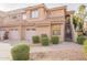 Charming townhome exterior featuring a private garage, landscaped front yard, and inviting staircase to the entrance at 5450 E Mclellan Rd # G227, Mesa, AZ 85205
