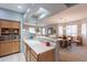 Open-concept kitchen with a breakfast bar, seamlessly connecting to the dining and living areas at 5450 E Mclellan Rd # G227, Mesa, AZ 85205