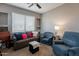 Comfortable living room with couch, lounge chairs, and a large sunlit window at 5450 E Mclellan Rd # G227, Mesa, AZ 85205