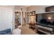 Cozy living area with French doors, comfortable seating, and a large television at 5450 E Mclellan Rd # G227, Mesa, AZ 85205