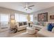 Comfortable living room with a plush sectional sofa, ceiling fan, and natural light from large windows at 5450 E Mclellan Rd # G227, Mesa, AZ 85205