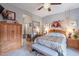Cozy main bedroom featuring a ceiling fan, bedside tables, and a spacious closet for ample storage at 5450 E Mclellan Rd # G227, Mesa, AZ 85205