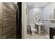 Cozy bathroom with a tiled shower, pedestal sink, and modern fixtures at 606 E Baseline Rd, Buckeye, AZ 85326