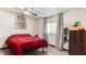 Comfortable bedroom with neutral tones, a large window, and a spacious closet at 606 E Baseline Rd, Buckeye, AZ 85326