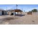 Wide driveway, covered parking and block fence for privacy in the backyard at 606 E Baseline Rd, Buckeye, AZ 85326