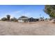 Charming gray home featuring desert landscaping and a chain-link fence at 606 E Baseline Rd, Buckeye, AZ 85326