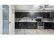 Well-equipped kitchen featuring dark cabinetry, stainless steel appliances, and ample counter space at 606 E Baseline Rd, Buckeye, AZ 85326