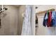 Modern shower with gray tile walls and a stylish shower curtain at 606 E Baseline Rd, Buckeye, AZ 85326