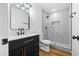 Modern bathroom with a stylish vanity, new lighting, and a beautifully tiled shower at 7160 W Virginia Ave, Phoenix, AZ 85035