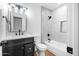 Bathroom with a tiled shower over tub, gray vanity, and modern lighting at 7160 W Virginia Ave, Phoenix, AZ 85035