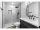 Bathroom with a tiled shower, modern vanity, and updated fixtures at 7160 W Virginia Ave, Phoenix, AZ 85035