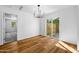 Dining room with wood floors, modern chandelier, and sliding glass doors to the backyard at 7160 W Virginia Ave, Phoenix, AZ 85035