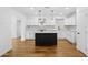 Bright, spacious kitchen with modern appliances, white cabinets, black island, and wood floor at 7160 W Virginia Ave, Phoenix, AZ 85035