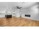 Open-concept living space with sleek flooring, contemporary fireplace, and modern ceiling fan at 7160 W Virginia Ave, Phoenix, AZ 85035