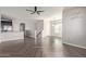 Open-concept living area with view of kitchen, staircase and luxury vinyl plank flooring at 7726 E Baseline Rd # 207, Mesa, AZ 85209