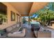 Relaxing covered patio with comfortable seating and views of the sparkling pool at 7776 E Sands Dr, Scottsdale, AZ 85255