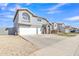 Charming two-story home featuring a three-car garage, manicured lawn, and stone accents at 900 E Rosebud Dr, San Tan Valley, AZ 85143