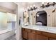 Bathroom featuring double sinks, vanity and shower/tub combination at 9014 E Sharon Dr, Scottsdale, AZ 85260