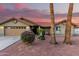 Charming home featuring desert landscaping, tile roof, and a two car garage at 9014 E Sharon Dr, Scottsdale, AZ 85260